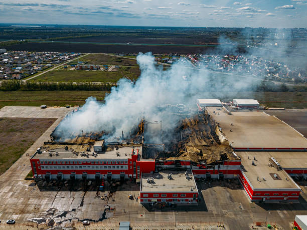 Burning industrial distribution warehouse, aerial drone view