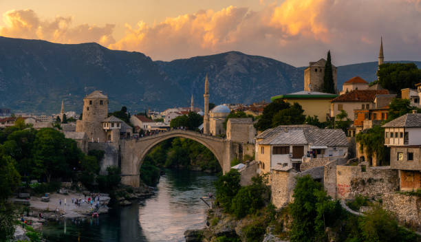 Skyline of Mostar with the Mostar Bridge against the beautiful evening sky Skyline of Mostar with the Mostar Bridge against the beautiful evening sky stari most mostar stock pictures, royalty-free photos & images