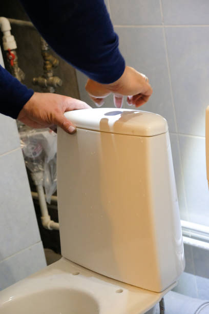 istock A plumber worker is installing a new toilet 1176705444