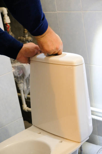 istock A plumber worker is installing a new toilet 1176705533