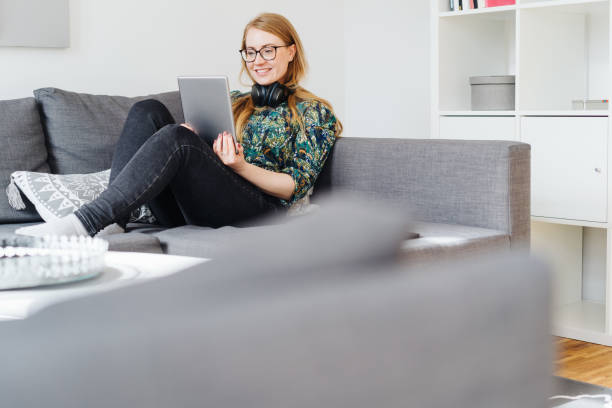 istock Young woman relaxing on a sofa at home 1176708615