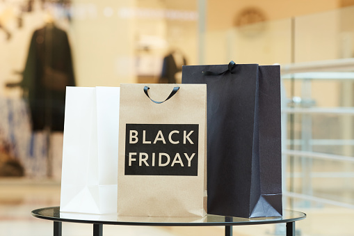 Image of black and white shopping bags standing on the table after black friday in the shopping mall