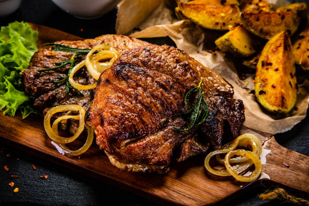 istock Grilled steak with sunny side up egg, fried potatoes and vegetable salad 1176709743