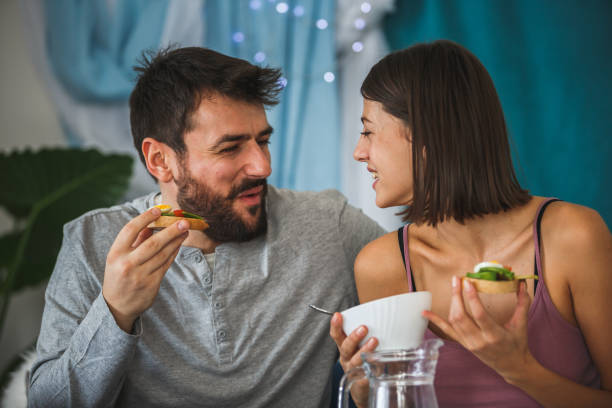 istock Smiling young couple enjoying delicious breakfast in bed 1176710090