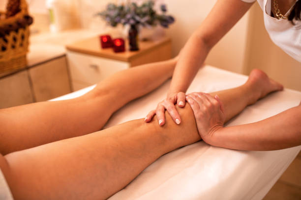 istock Masseuse working on a calf muscle area 1176710290