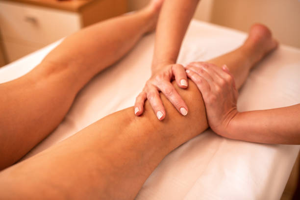 istock Masseuse working on a calf muscle area 1176710318