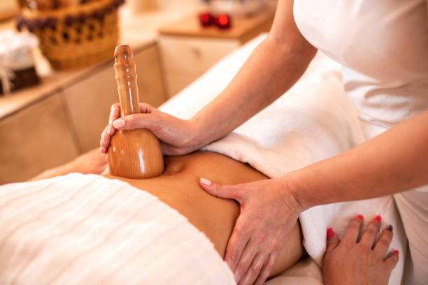 istock Stomach massage with hand held wooden tool 1176710948