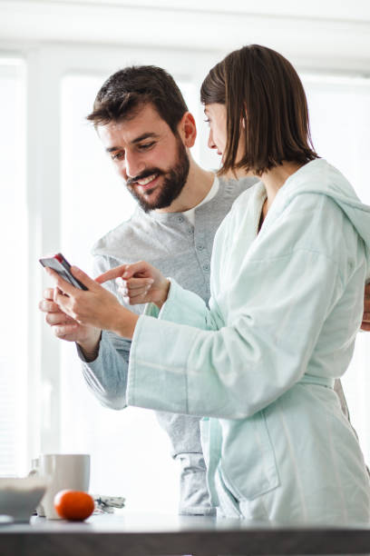 istock Happy young couple using smart phone in the morning 1176711461