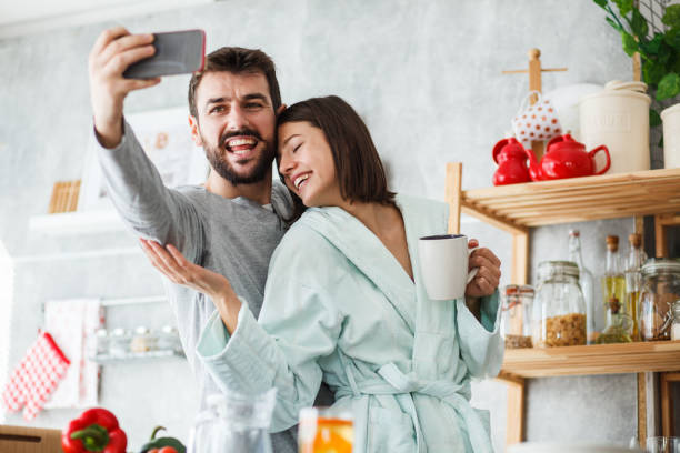 istock Affectionate couple taking a selfie together while enjoying morning coffee 1176711470