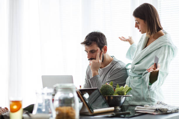 istock Couple engaging in relaxing conversation while using laptop in the morning 1176711481