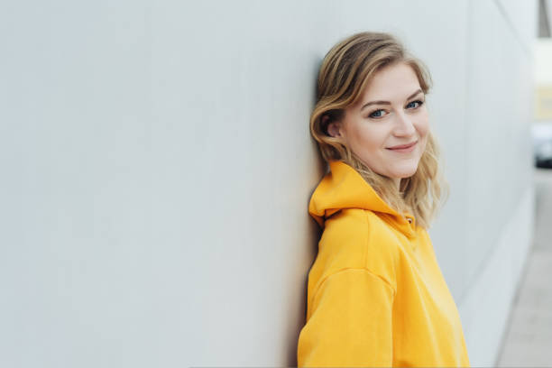 istock Happy relaxed woman leaning on a receding wall 1176711594