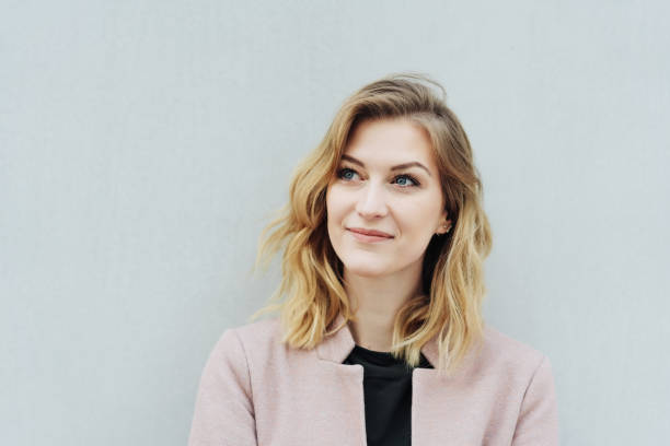 istock Contemplative young woman standing thinking 1176711645