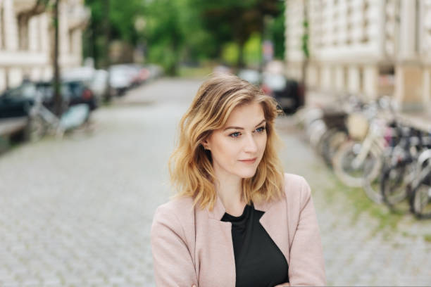 istock Serious young woman standing staring to the side 1176712623