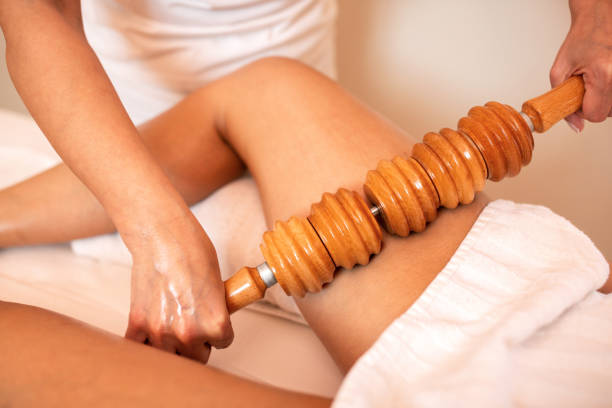 maderotherapy with a wooden roller - women tan perfection naked imagens e fotografias de stock