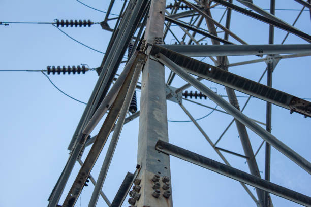 istock Close view of high voltage electric pole with blue sky background 1176713658