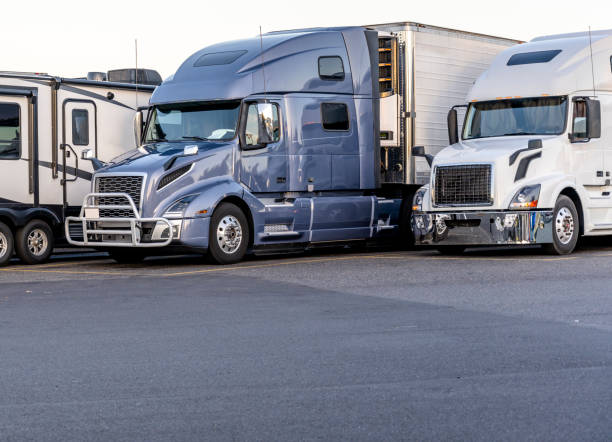 semi trucks stationed in a parking lot