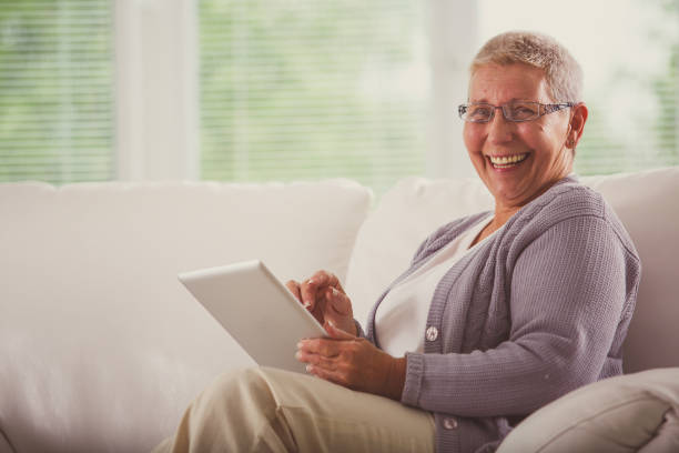 istock Happy senior woman using digital tablet 1176713953
