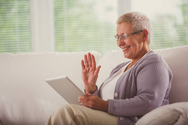 istock Senior woman having a video call on her digital tablet 1176713955