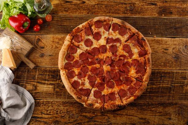 istock Pepperoni pizza on a wooden table. Still life with ingredients. 1176715717