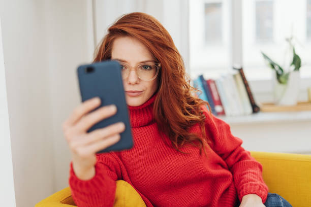istock Young woman reading on her mobile phone 1176715964