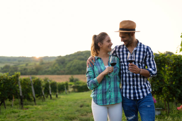 istock Woman and man in vineyard drinking wine 1176717059