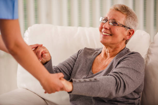 istock Senior woman holding nurses hands 1176718353