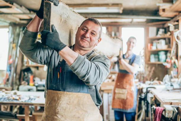 istock Carpenters carrying a wood plank 1176721004