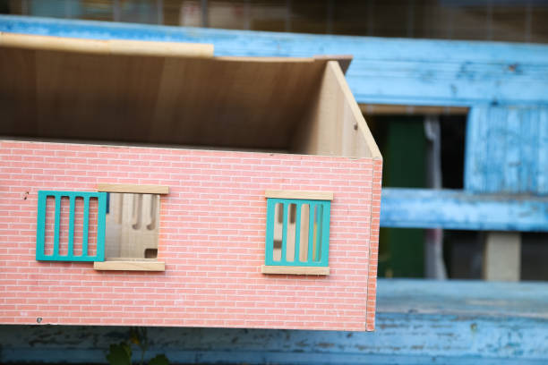 istock Wooden doll house on a rustic blue bench 1176721449