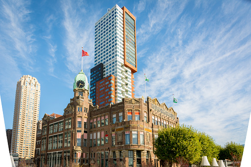 Rotterdam, Wilhelminapier, Netherlands, September 2019: View on the famous Hotel New York with Montevideo tower rising up in the background.