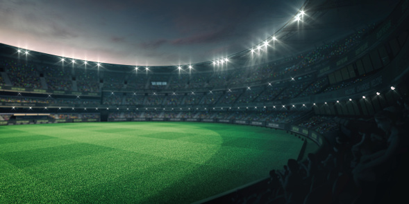 Luces del estadio y campo de césped verde vacío con ventiladores alrededor, vista tribuna en perspectiva photo