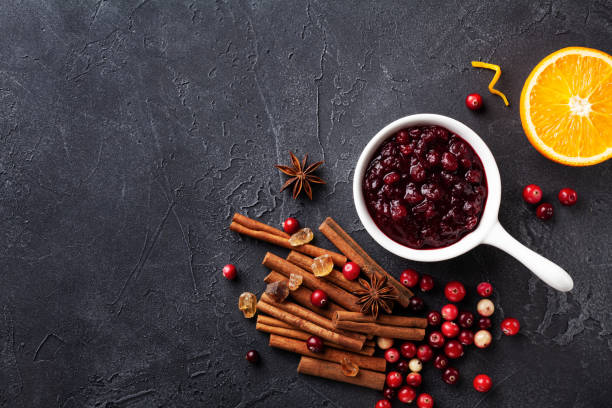 istock Cranberry sauce in ceramic saucepan with ingredients for cooking top view. 1176723536