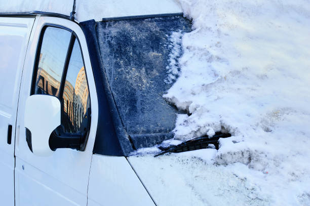 istock White car covered with snowdrift. In the winter outside. 1176724122