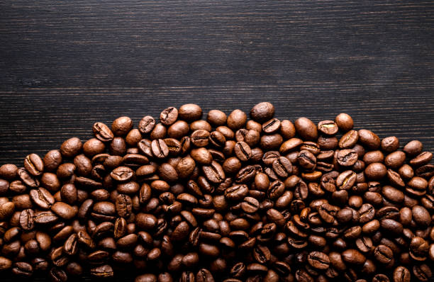 istock Coffee beans on wooden background. Macro. 1176724220