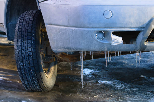 istock Old dirty car. Ice icicles on the bumper. Close-up. 1176724223