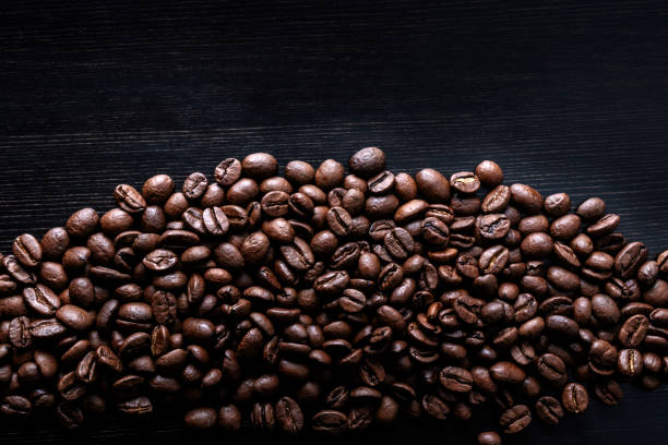 istock Coffee beans on wooden background. Macro. 1176724258