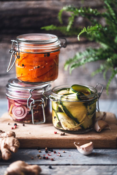 Vegetables Married in Pots. Carrot, Onion and Courgette Pickle for Winter. Vegetables Marinated in Pots. Pickle of Carrot, Onion and Zucchini for the Winter. preserved food stock pictures, royalty-free photos & images
