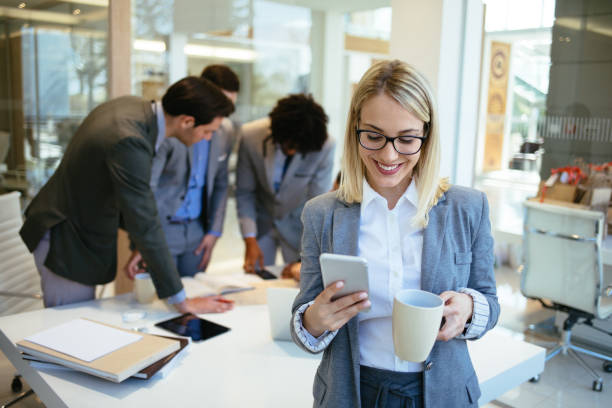 istock Young businesswoman using mobile in the office and text messaging 1176732180
