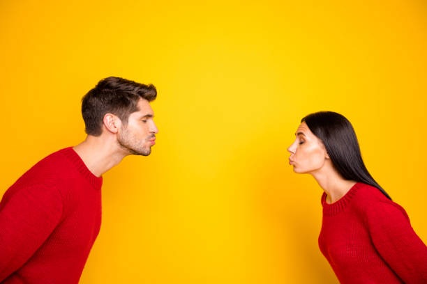 Profile side photo of charming spouses send air kiss wear red pullover isolated over vivid color background Profile side photo of charming spouses send air kiss wear red pullover, isolated over vivid color background blowing a kiss stock pictures, royalty-free photos & images