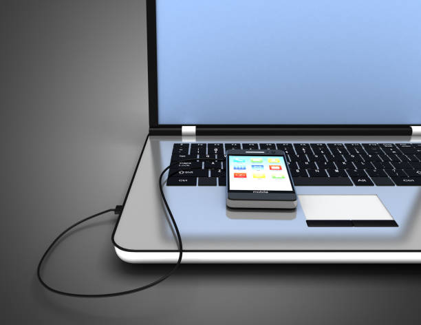 istock connected laptop and smartphone. 1176735710