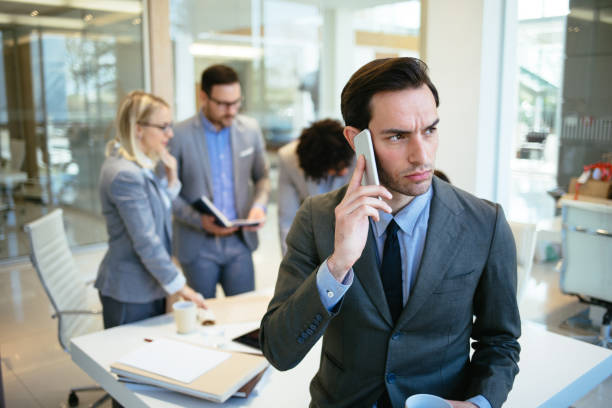 istock Businessman talking on mobile phone in the office 1176736172