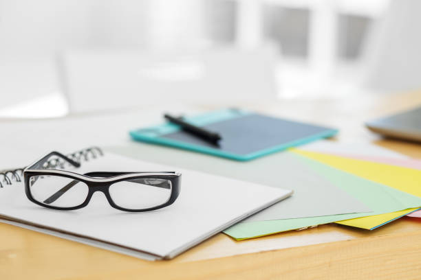 istock Glasses among the papers. Graphics tablet on the desktop. Free space for text. Office workplace. 1176737489