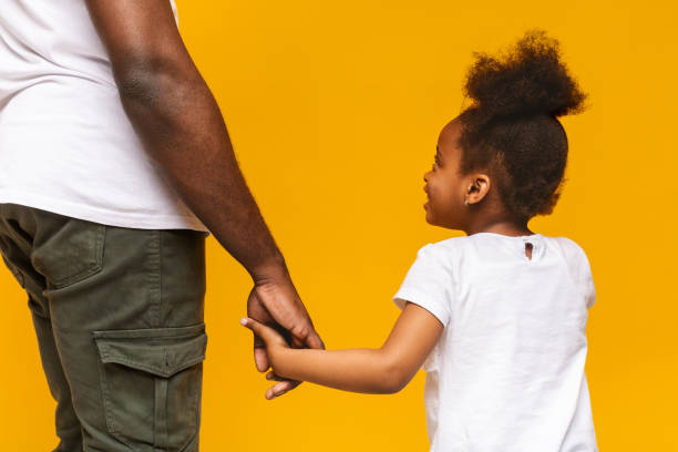 istock African father and little daughter holding hands 1176737594