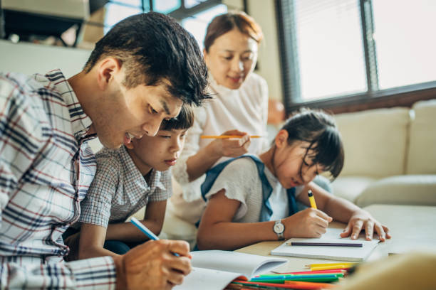 istock Parents doing homework with kids at home 1176738412