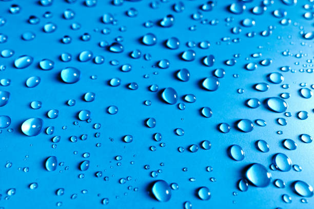 istock Close up Blue glass surface with clear water drops, background 1176739012