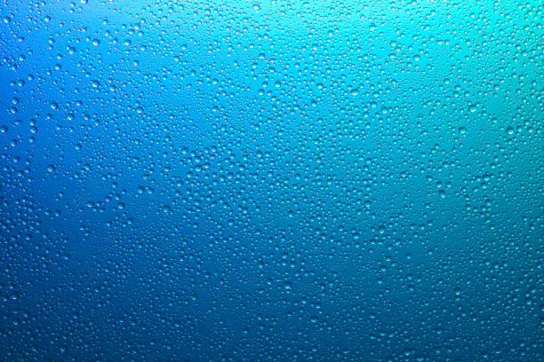 Water droplets on a translucent rainbow glass background with gradient