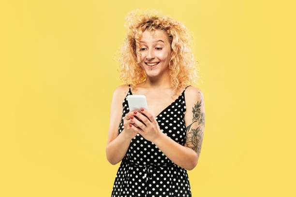 istock Caucasian young woman's half-length portrait on yellow background 1176739162
