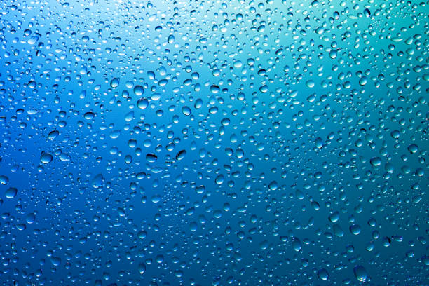 istock Water droplets on a translucent rainbow glass background with gradient 1176739279