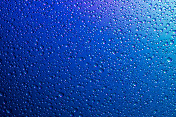 istock Water droplets on a translucent rainbow glass background with gradient 1176739420