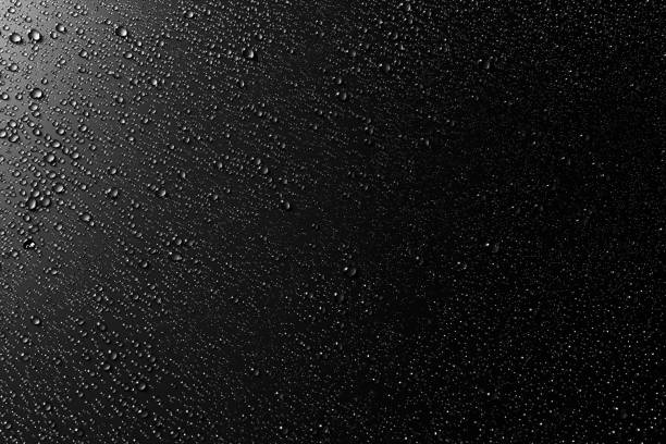 istock Drops of water on a black surface. Condensation, Top View. 1176739461