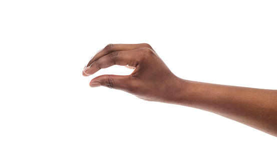 Black female hand measuring invisible items, woman's palm making gesture while showing small amount of something on white isolated background